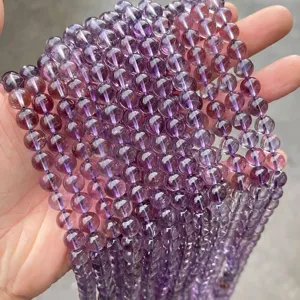 Close-up detail of natural purple amethyst round beads for DIY jewelry making