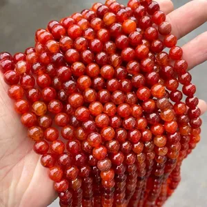 Detailed close-up of premium red dragon vein agate round beads for DIY jewelry making