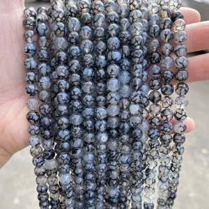 Macro view of black dragon vein agate beads showing unique natural crackle patterns for DIY