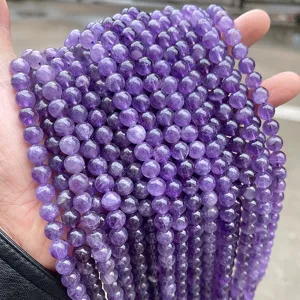 Detailed close-up of natural Uruguay purple amethyst round beads for DIY jewelry making
