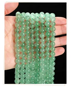 Close-up of 8mm natural green strawberry quartz round beads for DIY jewelry making