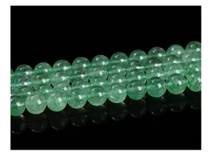 Macro shot of natural green strawberry quartz 8mm round beads for DIY jewelry making.