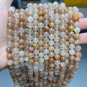 Detailed macro shot of natural red rutilated quartz round beads for DIY jewelry crafts