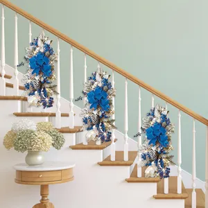 Blue and silver Christmas teardrop swags decorated on a white staircase railing