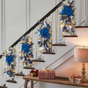 Decorative blue Christmas staircase swag garlands with warm LED lights and silver foliage