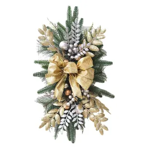 Elegant Christmas stair swag with gold glitter bow, pine branches and metallic ornaments