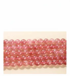 Close-up of natural strawberry quartz beads with clear mineral inclusions
