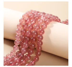 Detailed close-up of natural pink strawberry quartz round beads for DIY jewelry crafting
