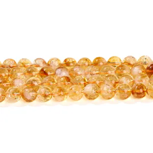 Natural citrine round loose beads for DIY jewelry making on white background