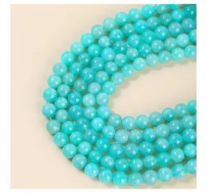 Macro view of polished natural amazonite round beads with crystalline texture