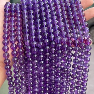Macro view of natural Uruguay purple amethyst round loose beads with vibrant texture