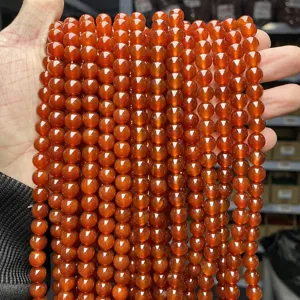Close-up detail of 5A red agate round beads for DIY jewelry making