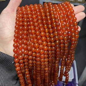 Close-up view of 5A grade red agate round beads showing natural texture and luster