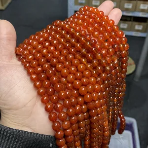 Close-up macro view of vibrant polished 5A red carnelian agate round beads for DIY jewelry