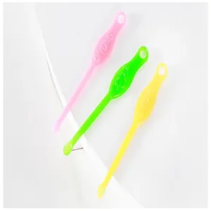 Detailed view of colorful plastic ear scoops, traditional home ear cleaning tool set.