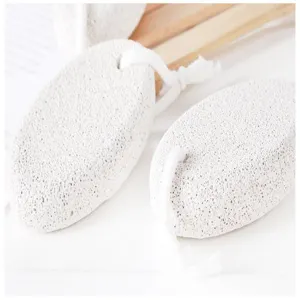 Close-up detail of white pumice stone with hanging rope for foot care and exfoliating.