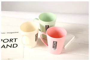 Simple plastic toothbrush cup, pastel colored wash mug with handle, daily bathroom accessory detail