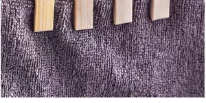 Detailed close-up view of natural bamboo laundry clips showing high-quality wooden texture.