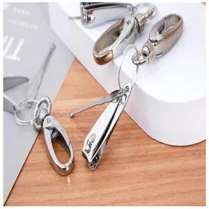 Detailed shot of multi-functional keychain nail clipper and ear pick metal tool set.