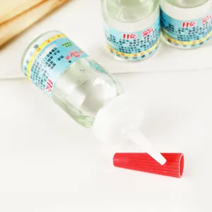 Set de colle forte liquide transparente avec embout de précision et bouchon rouge vif.