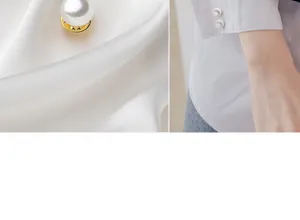 Detail shot of white pearl anti-glare button brooch, elegant decorative shirt accessory.