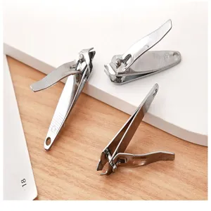 Stainless steel nail clipper set detail shot, sharp slanted edge fingernail trimmer tool.