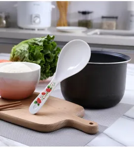 Detailed view of white melamine rice spoon featuring a red floral handle design for home kitchen.