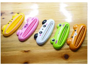 Cute cartoon animal toothpaste squeezer detail, colorful plastic manual tube dispenser.