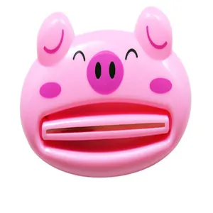 Detailed view of the cute pink cartoon pig toothpaste squeezer, perfect for daily bathroom use.