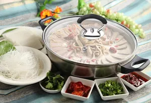 Stainless steel pot with glass lid and anti-scald silicone knob for kitchen cooking.
