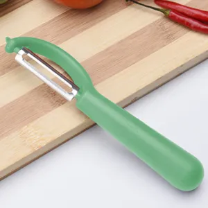 Stainless steel fruit vegetable peeler with ergonomic green handle for kitchen potato apple peeling.