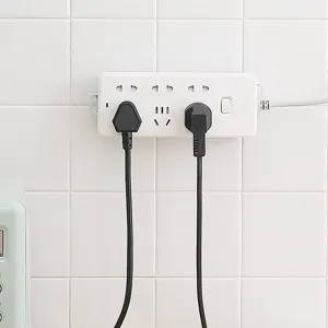 Wall-mounted white power strip with multiple outlets and switch on tile wall for home use.