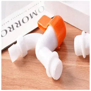 Close-up detail of plastic quick-open washing machine faucet with orange handle and white body.