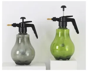Detail view of large pneumatic plastic spray bottles in grey and green colors for garden use.