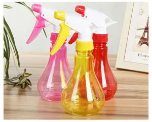 Plastic spray bottle set for garden watering, handheld pressurized water sprayer in colorful design.