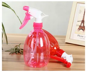 Plastic spray bottle detail showing transparent pink body and adjustable spray nozzle clearly.