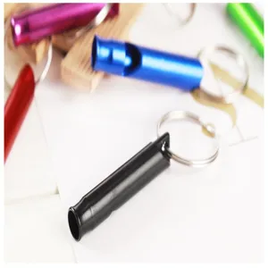 Aluminum survival whistle keychain pendant detail showing multi-color portable EDC gear.