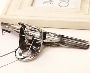 Stainless steel metal document binder clip close-up detail view showing spring mechanism.