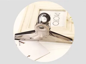 Stainless steel bulldog clip detail view, metal document paper clamp, heavy duty office supply tool.