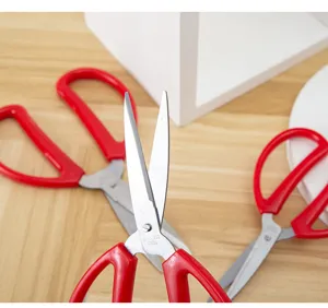 Stainless steel household scissors with red handle, multi-purpose tool for office and school crafts.