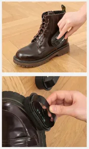 Vista dettagliata di uno stivale in pelle marrone pulito e lucidato con una spazzola per scarpe nera.