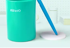 Turquoise plastic pen holder detail, featuring a blue pen and protective sponge base.