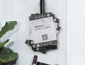 Detailed close-up view of office ticket spike with test paper notes hanging on light wall.