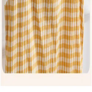 Yellow white gingham fabric detail, soft textile pattern close up view for apparel design.