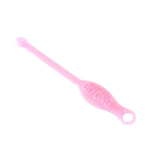 Pink plastic ear pick tool for daily earwax removal, compact portable design with hole.