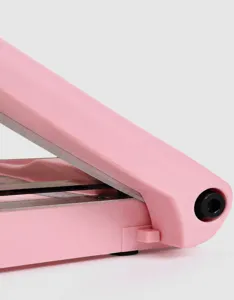 Pink portable A4 paper trimmer detail view, precise cutting tool for office and school use.
