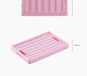 Pink foldable plastic storage crate detail view showing folded thickness of 2.2 cm.