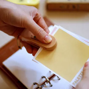 Portable mini keychain stapler for office and school stationery use, compact design.