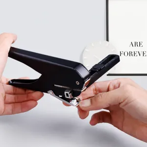 Single hole puncher with paper confetti collection box and positioning ruler for office stationery use.