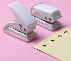 Detail view of white mini single hole puncher for stationery and diy paper binding crafts